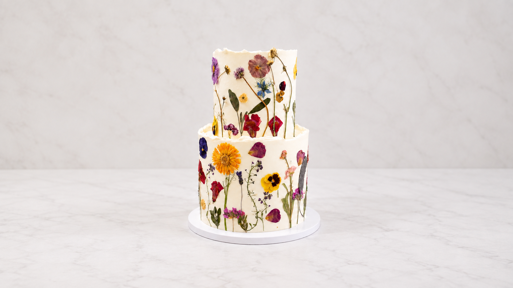 Sweet10 pressed flower cake with colorful botanical details